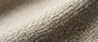Natural beige linen fabric with detailed woven texture showing intricate fiber patterns and soft lighting for textile and interior design projects.