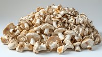 Fresh sliced white mushrooms pile on gray background, organic raw champignons heap isolated, natural healthy vegetarian food ingredient.