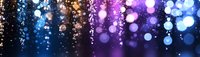 Magical glowing bokeh lights on dark background with blue and purple gradient colors creating dreamy atmospheric effect. For festive designs and celebrations.