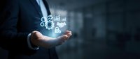 Businessman holding glowing digital icons representing modern technology and innovation in corporate environment for business presentations.