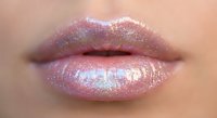 Glossy pink lips with holographic shimmer and iridescent gloss creating rainbow reflections on smooth skin for beauty and cosmetics applications.