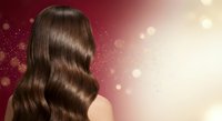 Luxurious brown wavy hair with glossy shine on elegant gradient background with golden bokeh lights for beauty and haircare advertising campaigns.