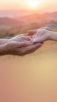 Cupped hands holding flowing light streams at golden hour sunset with mountain landscape background for spiritual and energy healing concepts.