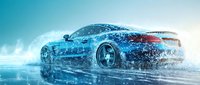 Luxury sports car speeding through water creating dramatic splash effect with blue tones and dynamic motion blur for automotive advertising.