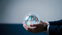 Businessman holding transparent crystal ball with futuristic city skyline and digital network connections inside for business vision and forecasting.