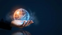 Hand holding glowing globe with shopping cart and growth chart, symbolizing global e-commerce expansion and digital retail success on dark background.