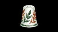 Ceramic thimble with decorative leaf motifs in green and rust tones, isolated on transparent background. Ready for clipart, print-on-demand, sublimation, and craft design projects.