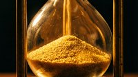 Golden sand flowing through an hourglass against a dark background, symbolizing the passage of time, deadline urgency, and temporal concepts for business and life management projects.