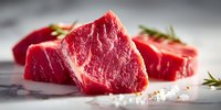 Fresh raw beef steaks with rosemary herbs and sea salt on marble surface ready for cooking and grilling in kitchen or restaurant preparation.