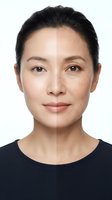 Asian woman face showing before after skin treatment results with half natural half retouched complexion on white background for beauty skincare concepts.