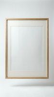 Empty wooden picture frame with white mat hanging on wall ready for artwork display and home decoration projects.
