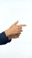 Business professional hands making finger gun gesture on white background isolated for presentations and corporate design concepts.