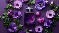 Purple perfume bottle surrounded by violet ranunculus flowers and green leaves on matching background for luxury cosmetics advertising.