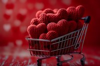 Red knitted hearts in miniature shopping cart on romantic background for Valentine's Day love concept and holiday celebration.