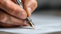 Close-up of male hand signing document with luxury fountain pen, capturing business agreement moment for corporate and legal concepts.