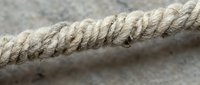 Natural hemp rope close-up showing detailed fiber texture and twisted strands for nautical, crafting, and industrial applications.