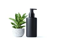 Minimalist black matte cosmetic pump bottle with houseplant in concrete pot on white background, mockup for skincare and beauty products packaging design.