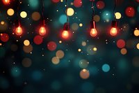 Glowing orange string lights against dark background with colorful bokeh effect creating magical festive atmosphere for holiday celebrations and events.