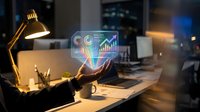 Businessman holding glowing holographic analytics dashboard with charts and graphs in modern dark office at night, showcasing futuristic data visualization.