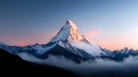 Majestic snow-capped mountain peak rising above clouds during golden hour sunrise with dramatic alpine landscape and serene morning atmosphere in wilderness.