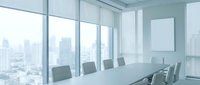 Modern conference room with white table, chairs and city skyline view through floor-to-ceiling windows for business meetings and corporate presentations.