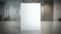 Blank white poster mockup standing on polished floor in modern office lobby with glass walls and professional lighting for branding presentations.