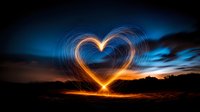Glowing heart shape created with light painting technique against dramatic sunset sky. Long exposure photography captures golden light trails forming romantic symbol.