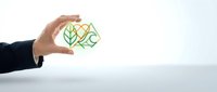 Business professional hand holding green recycling symbol representing environmental sustainability and eco-friendly corporate responsibility.