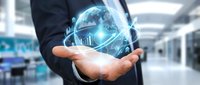Businessman in dark suit holding glowing digital globe with network connections in modern office environment, representing global business, technology, and international commerce.