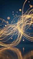 Golden flowing light trails with glowing particles on dark blue background creating dynamic energy waves and luminous motion effects for modern design.
