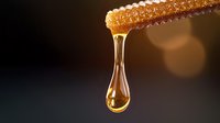 Fresh honeycomb dripping with golden honey drop against dark background with natural bokeh effect, macro food photography showing viscosity and sweetness.
