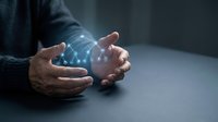 Businessman hands protecting glowing digital network connections representing cybersecurity, data protection and technology innovation in modern office environment.