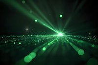 Abstract green light rays radiating from bright center point with bokeh particles and glowing dots creating dynamic perspective on dark background.