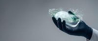 Hand holding holographic brain with digital neural networks and glowing connections representing artificial intelligence and neurotechnology concepts.