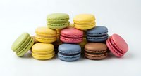 Colorful French macarons in various flavors arranged on white background, sweet pastry dessert treats for bakery and confectionery designs.