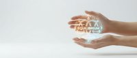 Hands holding glowing equilibrium scale symbol with balanced weight concept for business stability, fairness, and decision-making solutions.