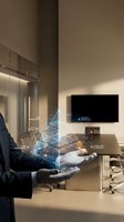 Businessman holding holographic data visualization with network connections in modern office conference room for technology presentations.