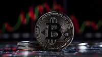 Silver bitcoin cryptocurrency coin against blurred red and green trading chart background, dramatic lighting highlights digital currency market volatility.