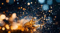 Dramatic water splash with golden and blue bokeh lights creating magical atmosphere against dark background, frozen motion of liquid droplets in air.