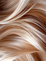 Flowing strands of blonde and brown hair create wavy pattern with highlights and lowlights, showing natural movement and shine for beauty and fashion concepts.