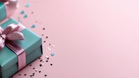 Elegant gift box in turquoise blue with pink satin ribbon bow on pastel pink background with scattered festive confetti, copy space for holiday message.