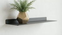 Geometric vase with green fern plant on modern floating shelf against white wall, minimalist home decor and interior design styling.