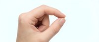 Caucasian hand making small gesture with thumb and index finger pinched together against white background, isolated for design use.