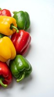 Fresh bell peppers in red, yellow, and green with water droplets arranged on white background for food and nutrition content.