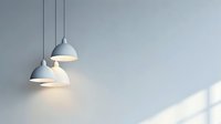 Modern white pendant lamps hanging against light gray wall with soft window light and shadow creating minimalist interior design composition.