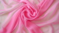 Soft pink silk fabric with elegant swirling folds and gentle waves creates luxurious flowing texture against light background, suitable for fashion and wedding designs.