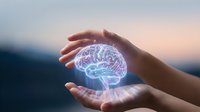 Protective hands surrounding glowing brain hologram symbolizing mental health care, neuroscience research, and cognitive protection concepts.
