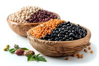 Assorted legumes in wooden bowls including chickpeas, red beans, orange lentils, and black beans with fresh herbs on white background.