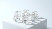 Clear transparent polyhedral dice set with numbers for tabletop gaming and role-playing games on white background isolated for design use.