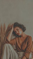 Young mixed-race woman with curly hair in contemplative pose wearing brown sweater and beige pants in minimalist interior with pampas grass decor.